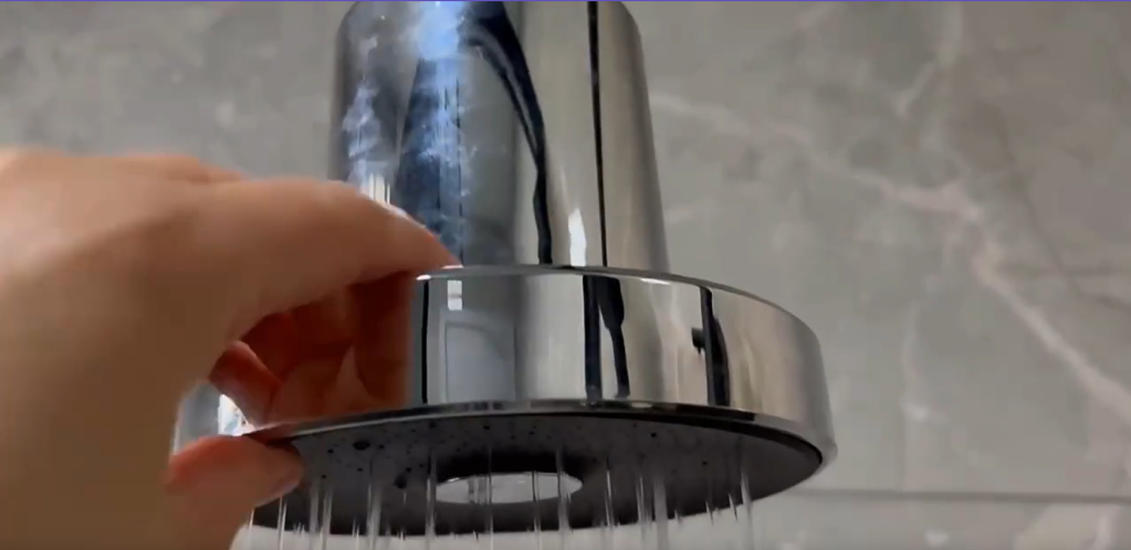 Hand installing a chrome showerhead filter